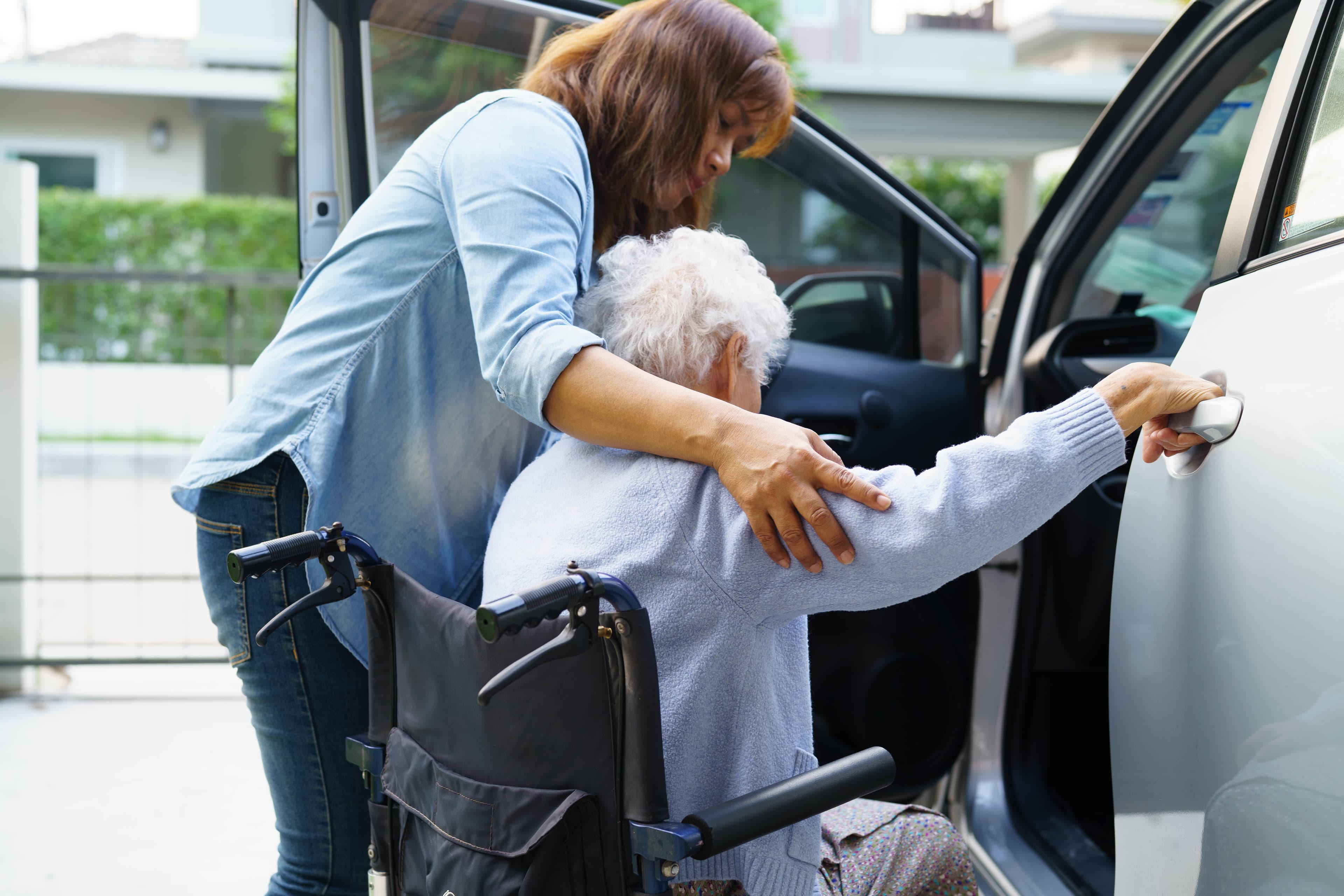 Support worker assisting NDIS participant with safe transport