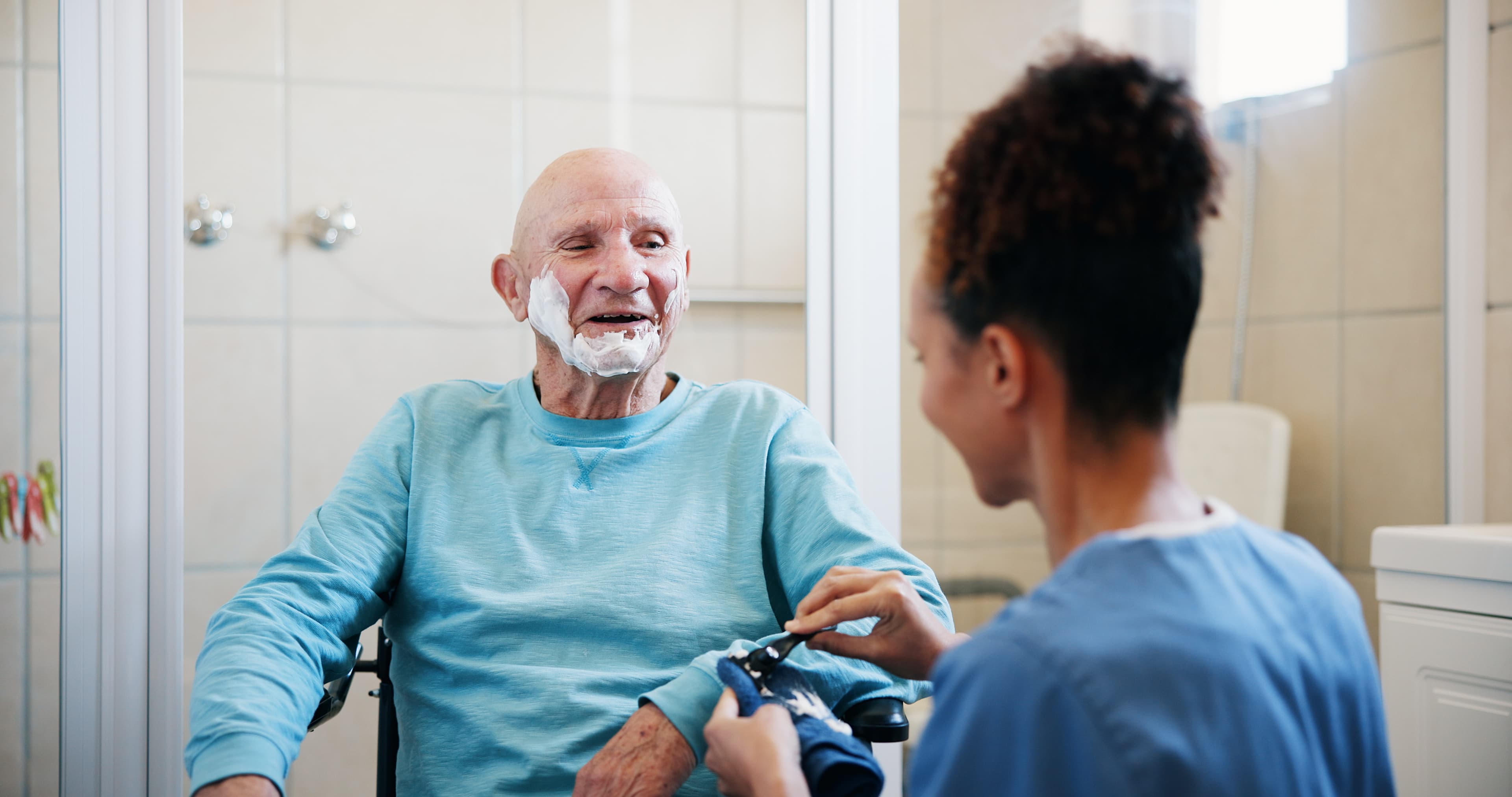 Support worker assisting NDIS participant with daily living activities at home