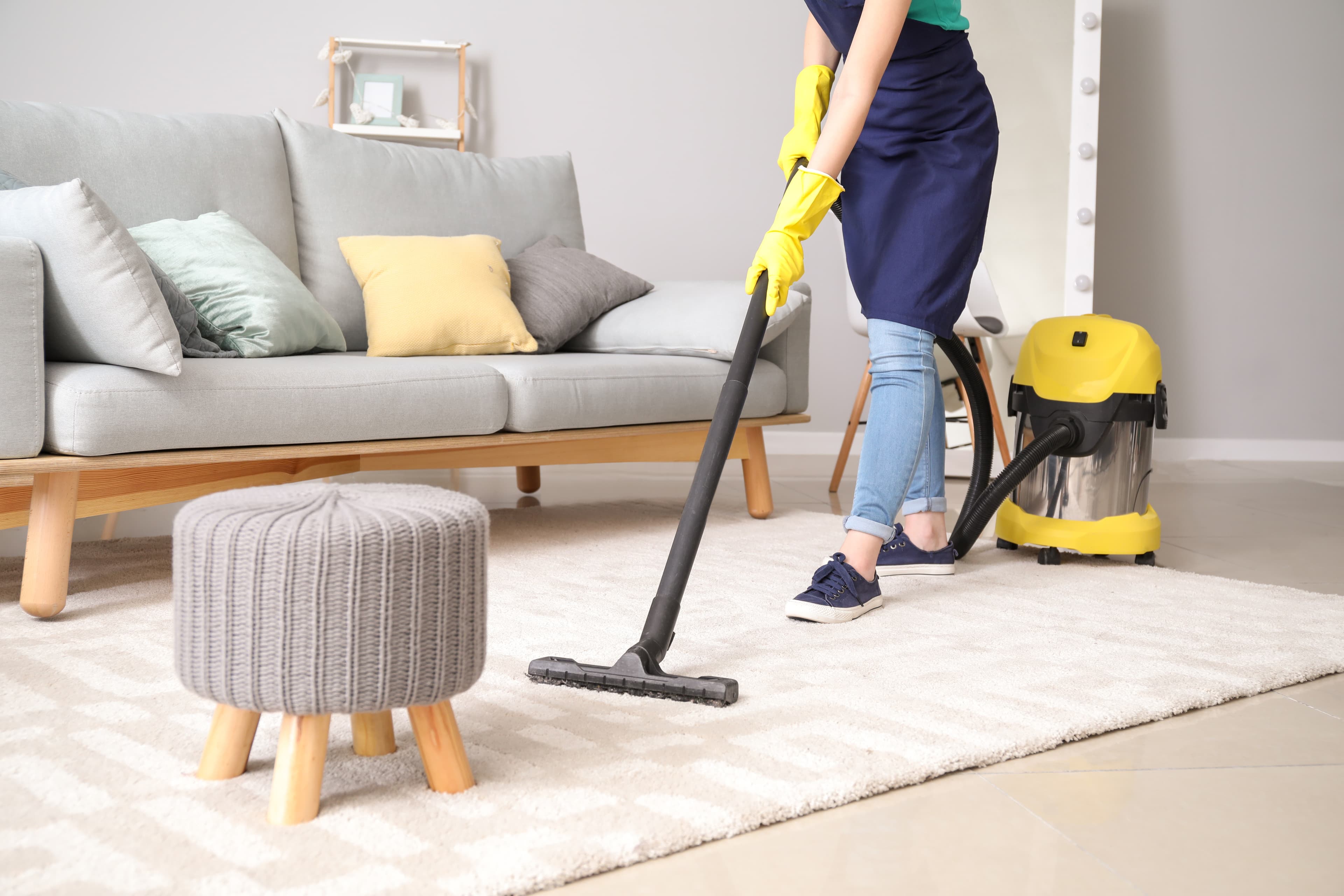 Support worker helping NDIS participant with household cleaning tasks